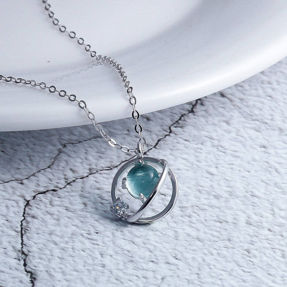 Planet crystal necklace pendant
S925 silver cosmic necklace
Crystal pendant jewelry closeup
Starry planet necklace detail