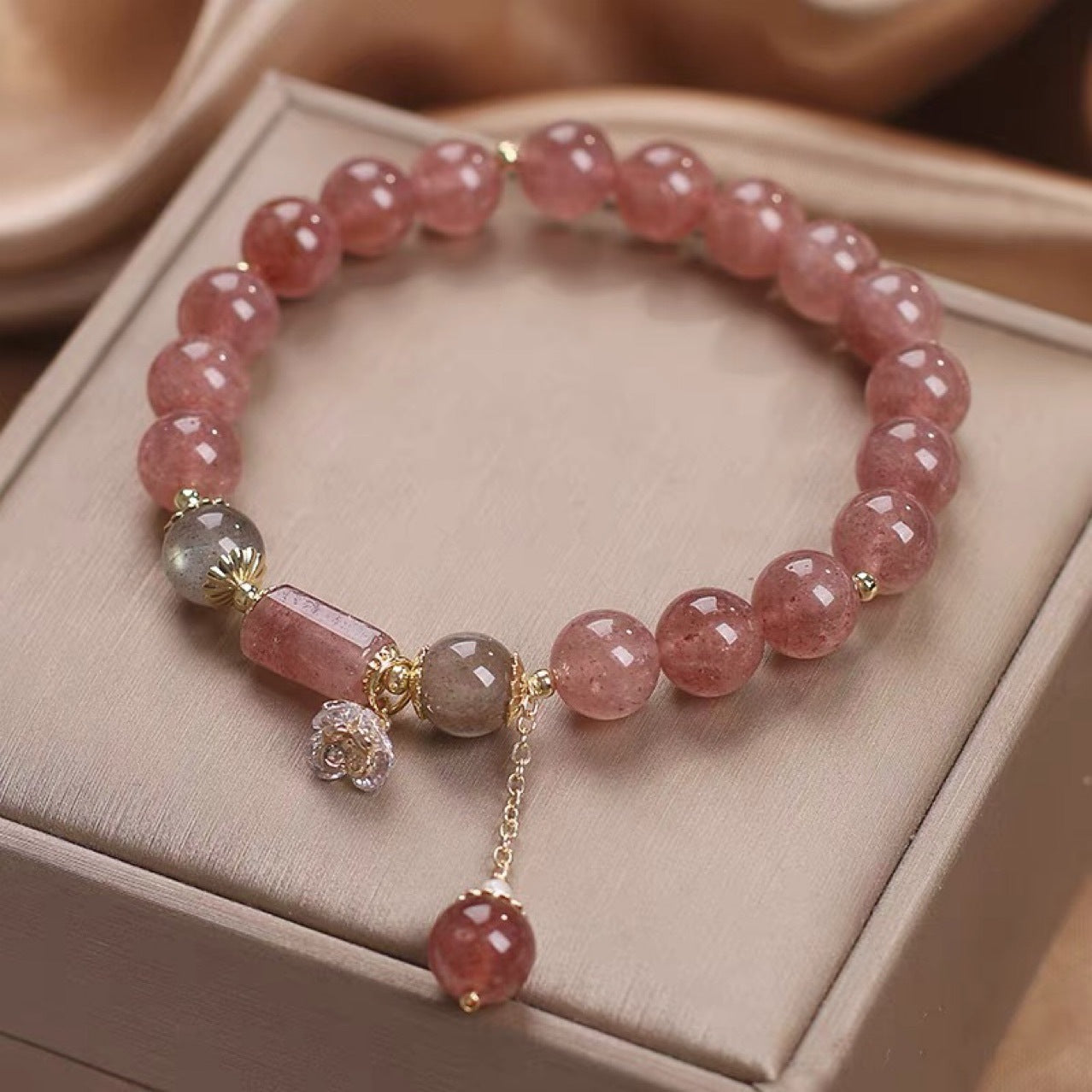 Pink strawberry quartz crystal bracelet with flower charm detail
