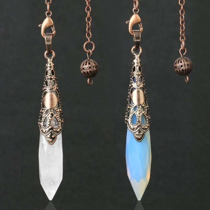 Clear quartz crystal point pendant with diamond cut hexagonal design on white backgro