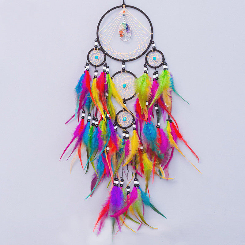 Handcrafted dreamcatcher close-up showing natural crystal centerpiece and feather details