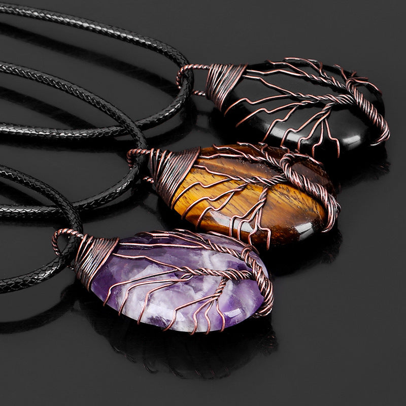 Handcrafted tree of life pendant featuring genuine natural crystal - detail close up