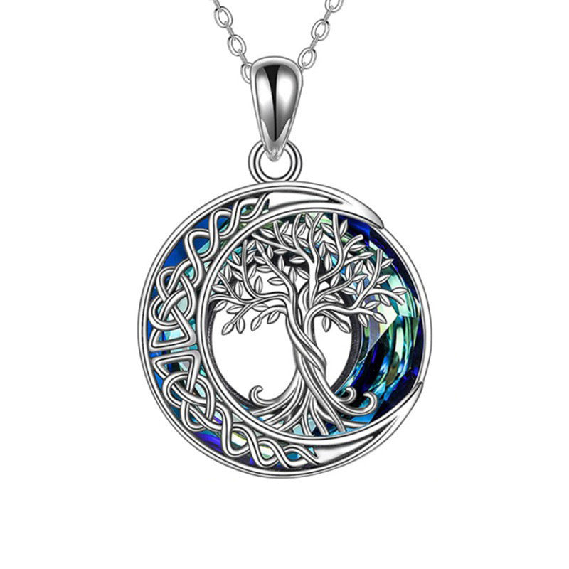 Tree of life pendant close-up showing crystal details and crescent moon design